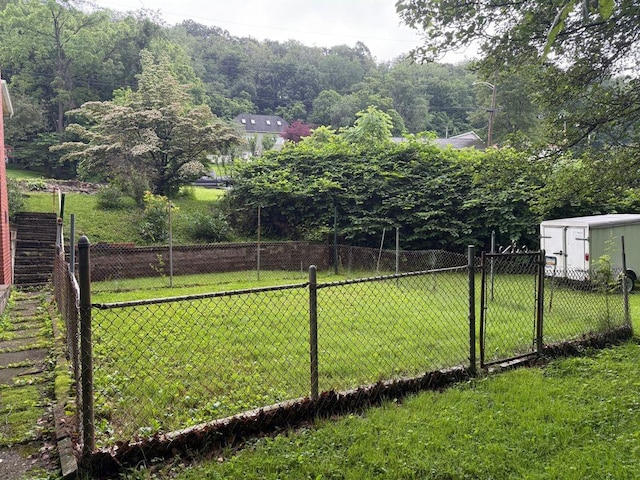 717 King St, Mckeesport, PA 15132 - view of yard featuring a storage unit and a gate