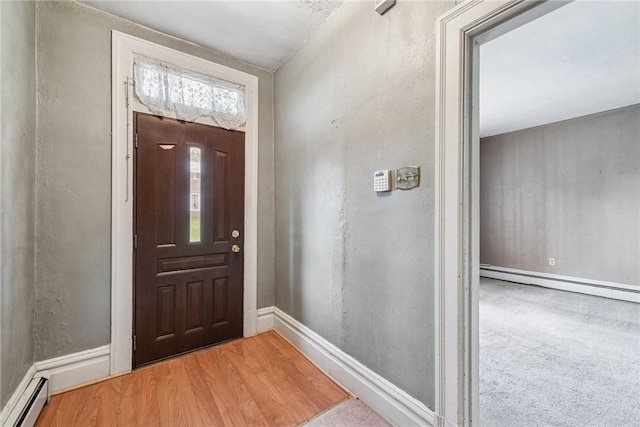 373 Copperfield Ave, Carrick, PA 15210 - foyer featuring a baseboard heating unit and wood finished floors