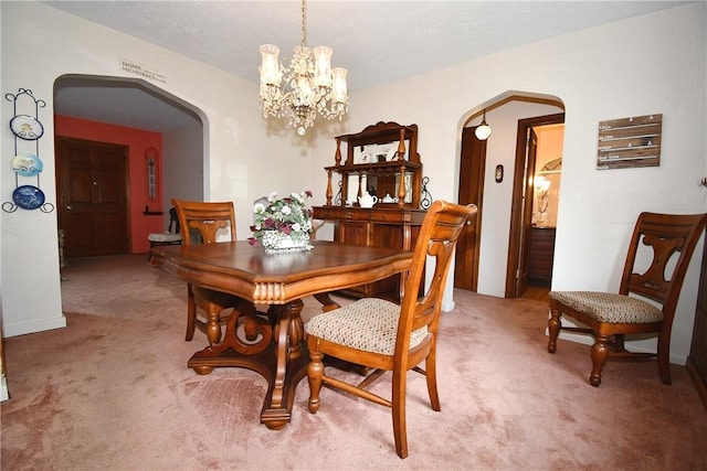 1673 Elderslee Rd, Baldwin Boro, PA 15227 - dining area featuring arched walkways, light colored carpet, and a chandelier