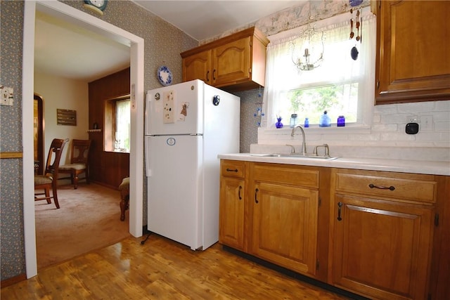 1673 Elderslee Rd, Baldwin Boro, PA 15227 - kitchen featuring freestanding refrigerator, healthy amount of natural light, brown cabinetry, wallpapered walls, and light countertops
