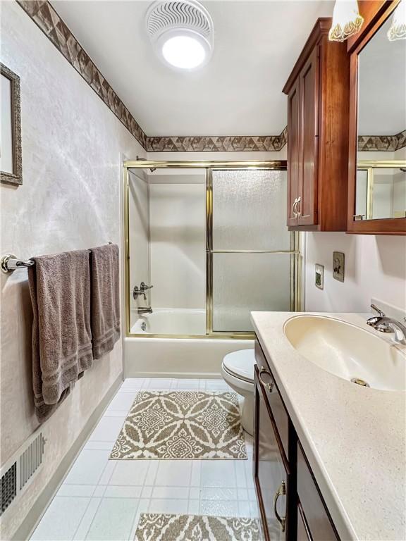321 Jo Ann Dr, West Mifflin, PA 15122 - full bathroom featuring bath / shower combo with glass door, vanity, and tile patterned floors