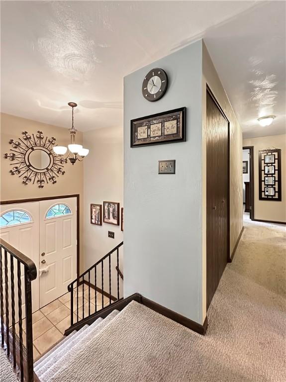 321 Jo Ann Dr, West Mifflin, PA 15122 - hall featuring a chandelier, an upstairs landing, and light carpet
