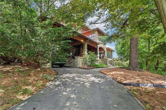 221 E Moody Ave, New Castle/2Nd, PA 16101 - view of front of house featuring asphalt driveway, stone siding, and covered porch