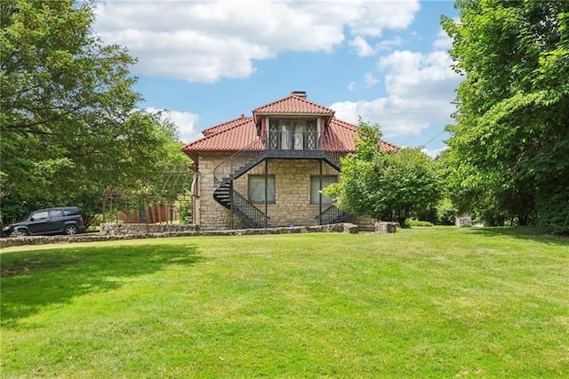 221 E Moody Ave, New Castle/2Nd, PA 16101 - rear view of property featuring stairs, stone siding, a chimney, a tiled roof, and a yard