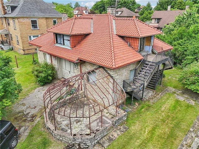 221 E Moody Ave, New Castle/2Nd, PA 16101 - rear view of property with a tile roof, stone siding, stairway, and a chimney