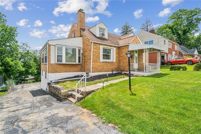 3176 Churchview Ave, Baldwin Boro, PA 15227 - view of front of home with brick siding, a front lawn, and a chimney