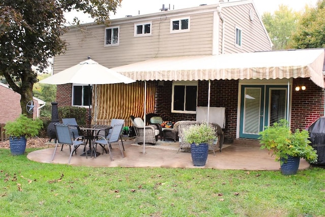77 Ridgecrest Dr, Wilkins Twp, PA 15235 - rear view of house featuring brick siding, a patio area, and a lawn