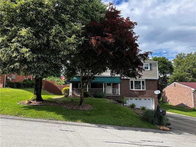 77 Ridgecrest Dr, Wilkins Twp, PA 15235 - view of property hidden behind natural elements featuring brick siding, driveway, a garage, and a porch