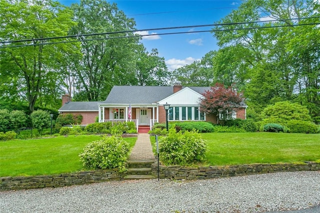 126 Elm Dr, Level Green, PA 15085 - view of front of home featuring a chimney, covered porch, brick siding, and a front lawn