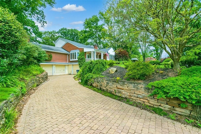 126 Elm Dr, Level Green, PA 15085 - view of front of home featuring decorative driveway, an attached garage, and brick siding