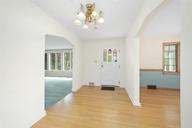 126 Elm Dr, Level Green, PA 15085 - foyer featuring arched walkways, a chandelier, and healthy amount of natural light