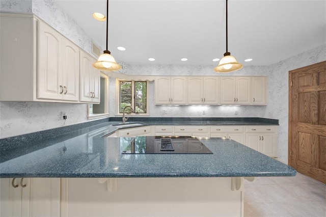 126 Elm Dr, Level Green, PA 15085 - kitchen featuring black electric stovetop, recessed lighting, hanging light fixtures, a peninsula, and dark stone counters