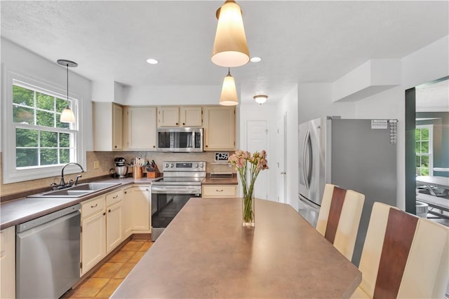 406 Pin Oak Ct, Coraopolis, PA 15108 - kitchen with appliances with stainless steel finishes, backsplash, decorative light fixtures, cream cabinetry, and recessed lighting
