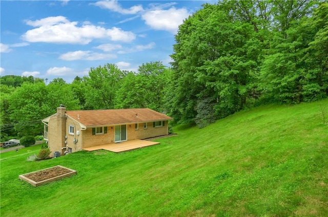 156 Dwellington Dr, Middlesex Twp, PA 16059 - rear view of property with a lawn, a chimney, a wooded view, and a wooden deck