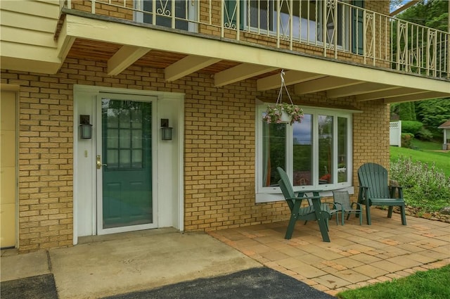 156 Dwellington Dr, Middlesex Twp, PA 16059 - property entrance with brick siding, a balcony, and a patio