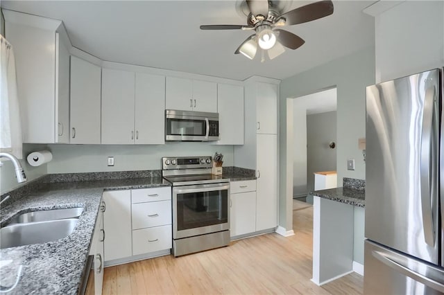 156 Dwellington Dr, Middlesex Twp, PA 16059 - kitchen featuring stainless steel appliances, white cabinets, light wood-style floors, and ceiling fan