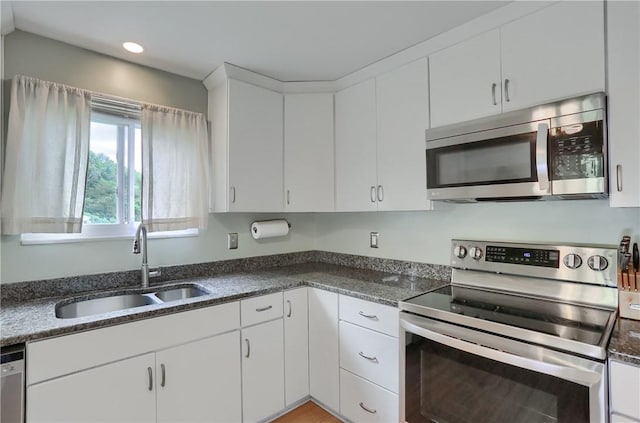 156 Dwellington Dr, Middlesex Twp, PA 16059 - kitchen featuring appliances with stainless steel finishes, white cabinets, recessed lighting, and dark stone countertops