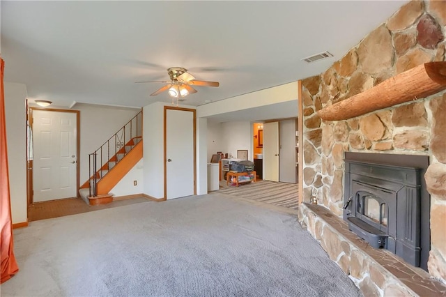 156 Dwellington Dr, Middlesex Twp, PA 16059 - unfurnished living room with a ceiling fan, carpet flooring, a wood stove, and stairs