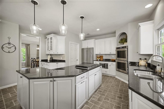 140 Golfview Dr, Adams Twp, PA 15044 - kitchen with stainless steel appliances, decorative backsplash, a kitchen island, white cabinets, and recessed lighting