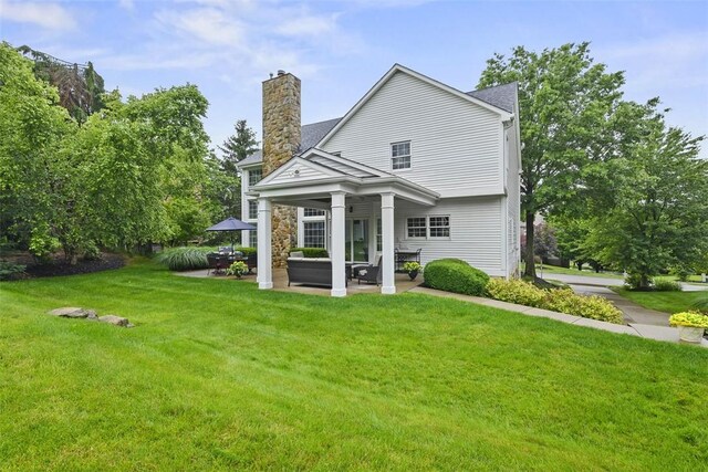 140 Golfview Dr, Adams Twp, PA 15044 - back of property with a patio, a chimney, a lawn, and stone siding