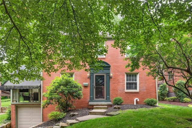 314 Sleepy Hollow Rd, Mt Lebanon, PA 15228 - view of front of home featuring brick siding, a front lawn, and an attached garage
