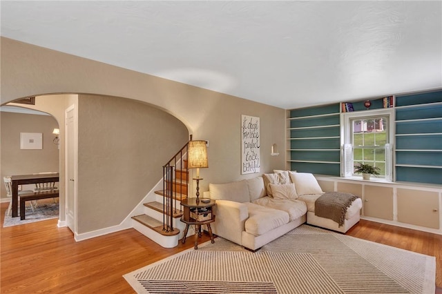 314 Sleepy Hollow Rd, Mt Lebanon, PA 15228 - living area featuring arched walkways, wood finished floors, built in features, and stairway