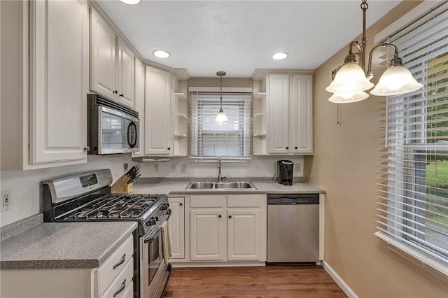 314 Sleepy Hollow Rd, Mt Lebanon, PA 15228 - kitchen with stainless steel appliances, open shelves, wood finished floors, white cabinetry, and decorative light fixtures