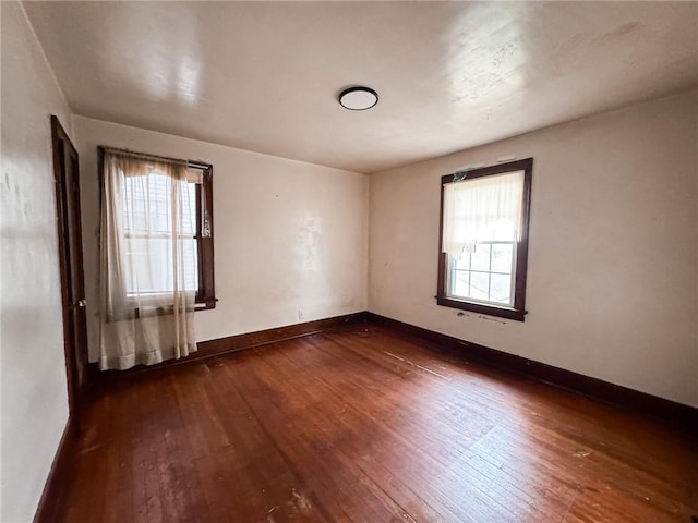 2406 Banker St, Mckeesport, PA 15132 - empty room featuring dark wood-style flooring and plenty of natural light