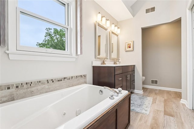 1386 Royal Oak Dr, Marshall, PA 15090 - full bath featuring vanity, a tub with jets, wood finished floors, and vaulted ceiling