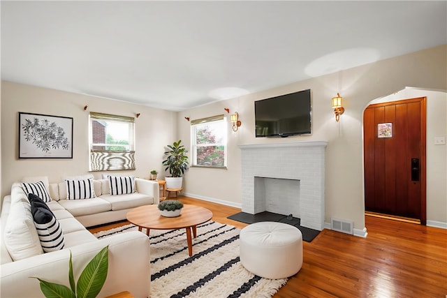 129 Temona Dr, Pleasant Hills, PA 15236 - living room with wood finished floors and a brick fireplace