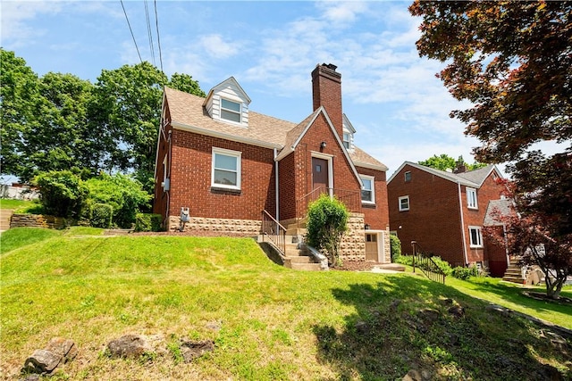 129 Temona Dr, Pleasant Hills, PA 15236 - view of front facade with a chimney, brick siding, a front yard, and stairs