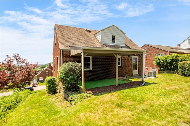 129 Temona Dr, Pleasant Hills, PA 15236 - rear view of property featuring brick siding, a lawn, and roof with shingles