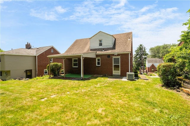 129 Temona Dr, Pleasant Hills, PA 15236 - rear view of house featuring brick siding, a lawn, and a patio area