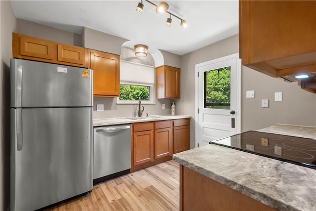 129 Temona Dr, Pleasant Hills, PA 15236 - kitchen featuring appliances with stainless steel finishes, light wood-type flooring, light countertops, brown cabinetry, and rail lighting