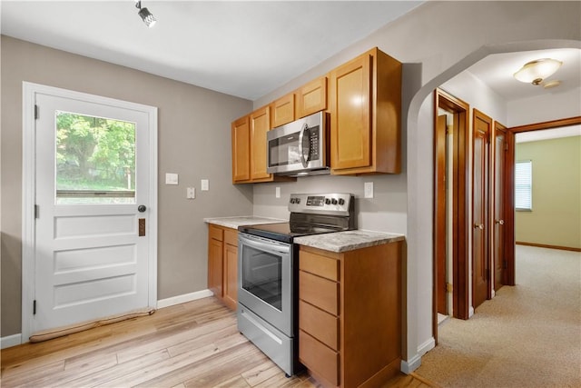 129 Temona Dr, Pleasant Hills, PA 15236 - kitchen with stainless steel appliances, arched walkways, plenty of natural light, and light countertops
