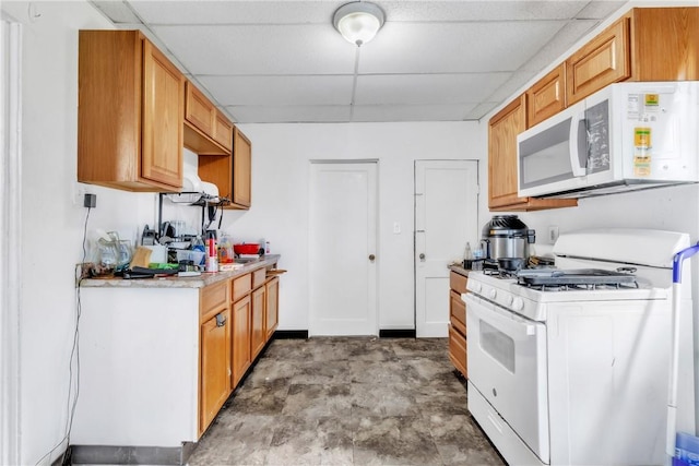 957-959 5th Ave, East Mckeesport, PA 15035 - kitchen with white appliances, a paneled ceiling, and light countertops