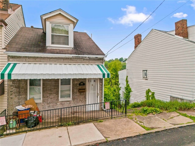 1908 Saint Paul St, South Side, PA 15203 - view of front of property with a fenced front yard, a porch, and brick siding