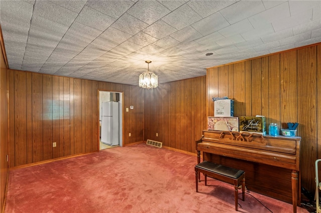 1908 Saint Paul St, South Side, PA 15203 - living area featuring carpet, a chandelier, and wood walls