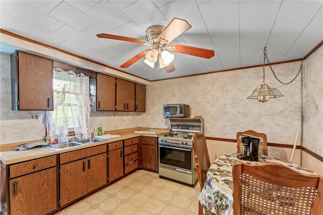 1908 Saint Paul St, South Side, PA 15203 - kitchen featuring white gas range, stainless steel microwave, light countertops, wallpapered walls, and brown cabinetry