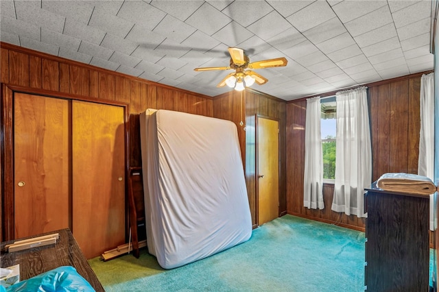 1908 Saint Paul St, South Side, PA 15203 - unfurnished bedroom featuring wooden walls, carpet floors, and a ceiling fan