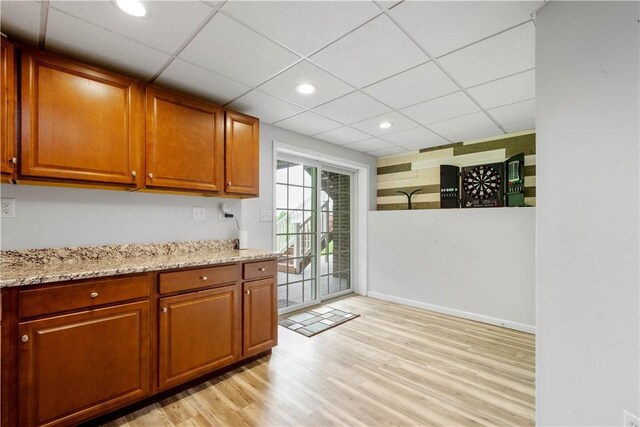 97 Clover Ln, Pine Twp Nal, PA 15044 - kitchen with light wood-type flooring, light stone countertops, brown cabinetry, recessed lighting, and a paneled ceiling