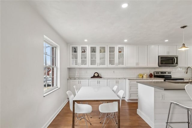 221 Miller Ave, Duquesne, PA 15110 - kitchen with appliances with stainless steel finishes, tasteful backsplash, recessed lighting, white cabinetry, and glass insert cabinets