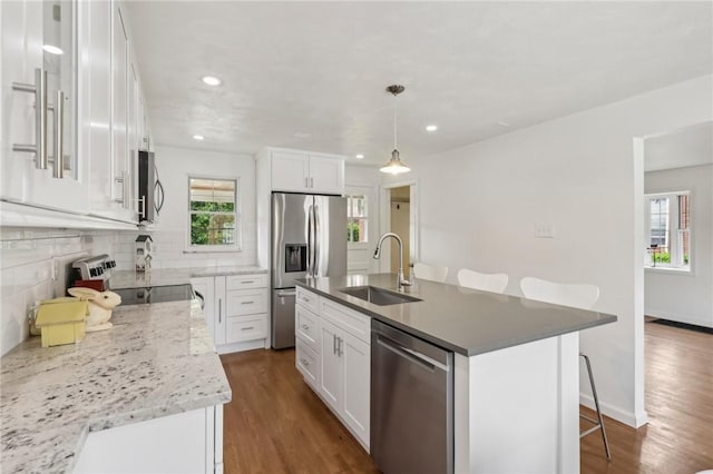 221 Miller Ave, Duquesne, PA 15110 - kitchen featuring appliances with stainless steel finishes, tasteful backsplash, a breakfast bar, white cabinets, and recessed lighting