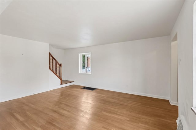 221 Miller Ave, Duquesne, PA 15110 - unfurnished living room with stairs and light wood-style floors