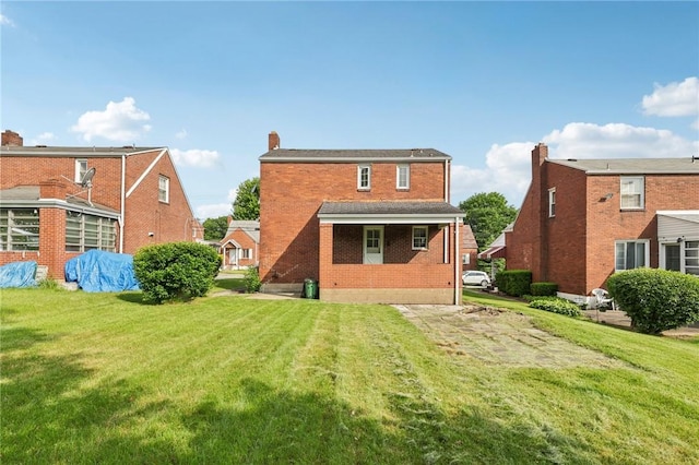 221 Miller Ave, Duquesne, PA 15110 - rear view of house featuring a lawn, a chimney, and brick siding