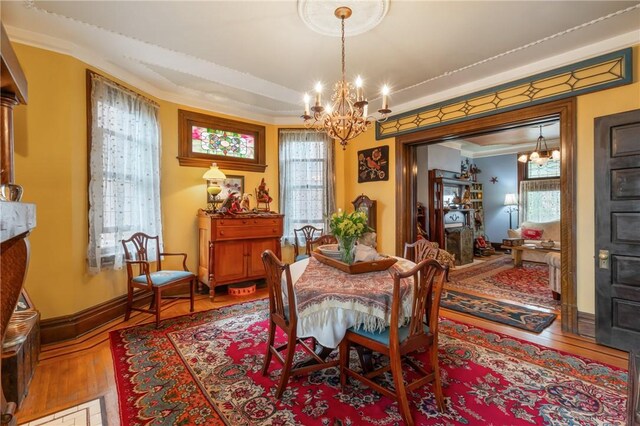 125 Richey Ave, Observatory Hill, PA 15214 - dining space featuring a chandelier, wood finished floors, healthy amount of natural light, and crown molding