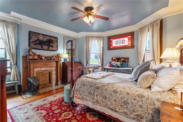 125 Richey Ave, Observatory Hill, PA 15214 - bedroom with wood finished floors, multiple windows, a fireplace, a ceiling fan, and ornamental molding