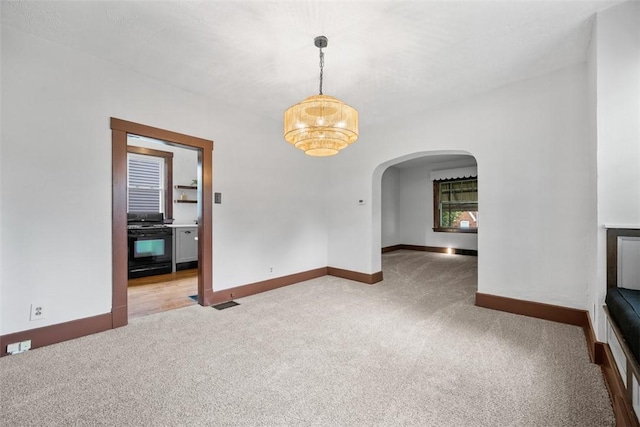 3123 Willett Rd, Brentwood, PA 15227 - carpeted spare room with arched walkways and a chandelier