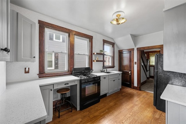 3123 Willett Rd, Brentwood, PA 15227 - kitchen with black gas range, light countertops, light wood-style flooring, and lofted ceiling