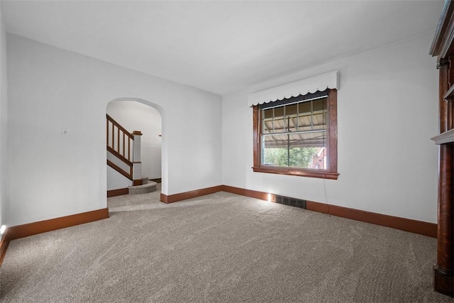 3123 Willett Rd, Brentwood, PA 15227 - empty room featuring arched walkways, carpet floors, and stairs